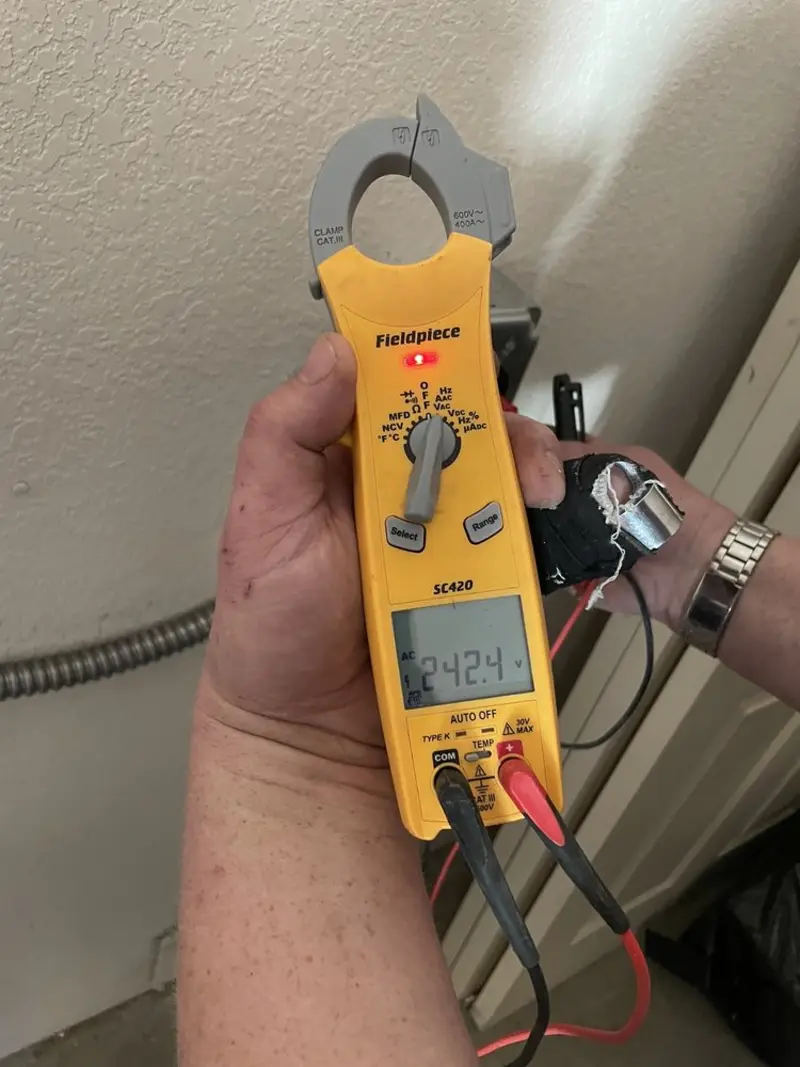 Voltage testing with clamp meter during Outlet Installation in Lennox